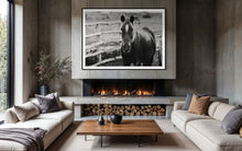 Load image into Gallery viewer, Elegant interior featuring a framed black and white photograph of a horse, titled 'Limited Edition Horse Pictures - Morose Molly 0211 by Addison Jones Studio', hanging above a modern fireplace and cozy seating.