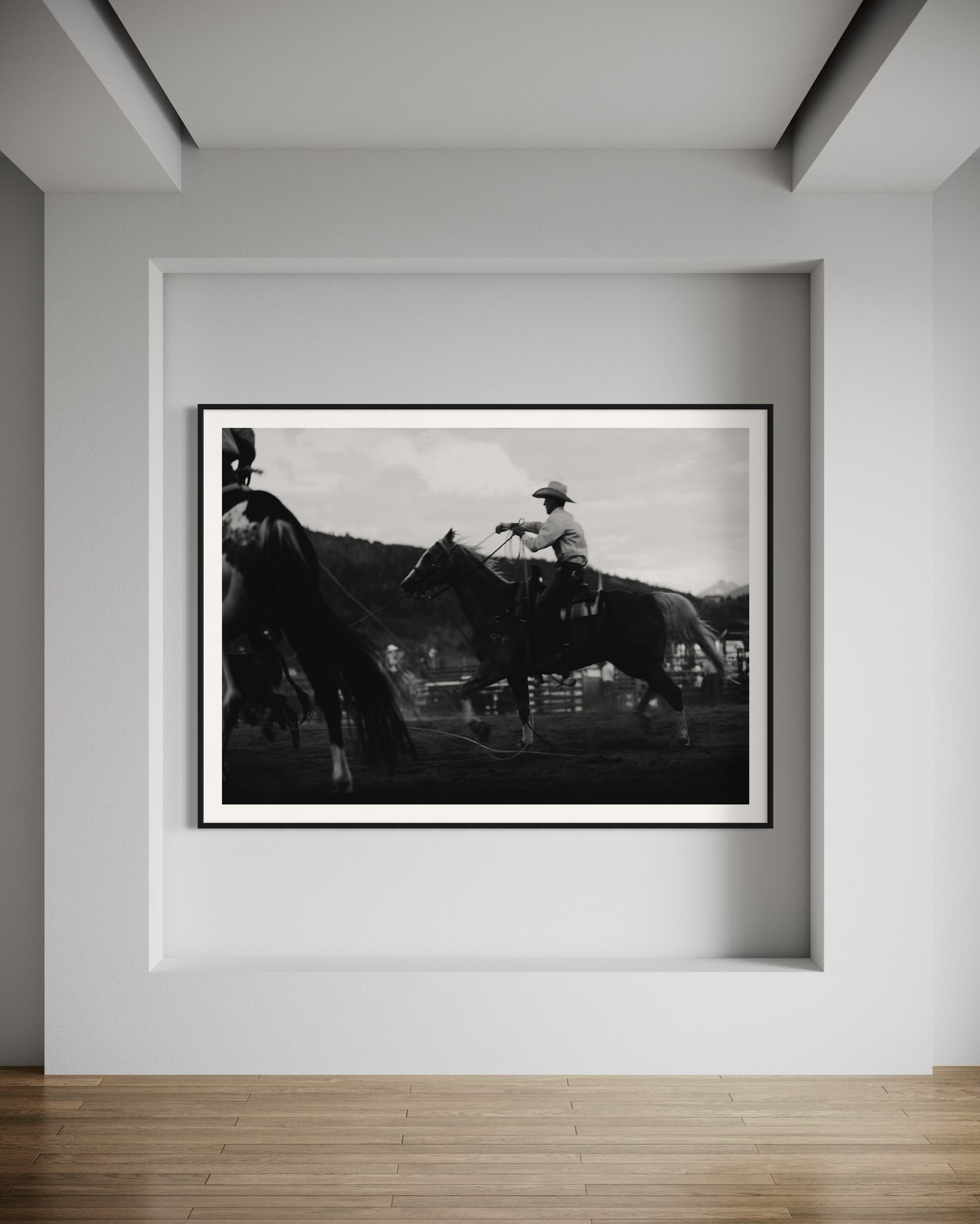 Elegant interior with the black and white photography 'Gallant Gallup' by Addison Jones Studio framed on a wall, capturing the essence of cowboy culture.