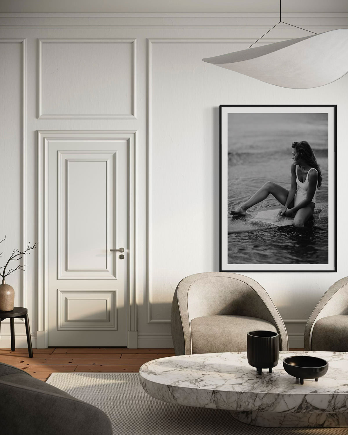 A sophisticated living room featuring the framed photography 'Riding Tide', depicting a woman in a white swimsuit enjoying the ocean on her surfboard, adding a beachy ambiance to the space.