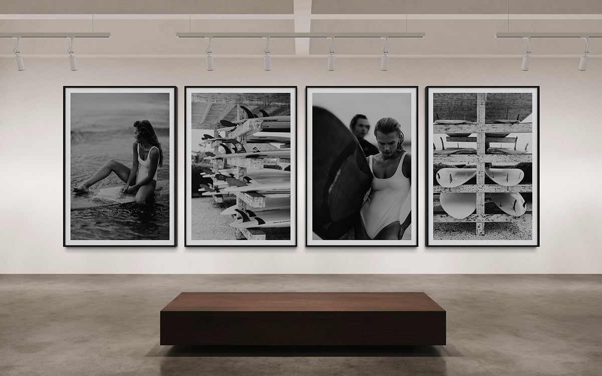 An art gallery scene showcasing multiple framed photographs, including 'Riding Tide,' featuring a woman on a surfboard, enhancing the cultural and artistic vibe of the space.