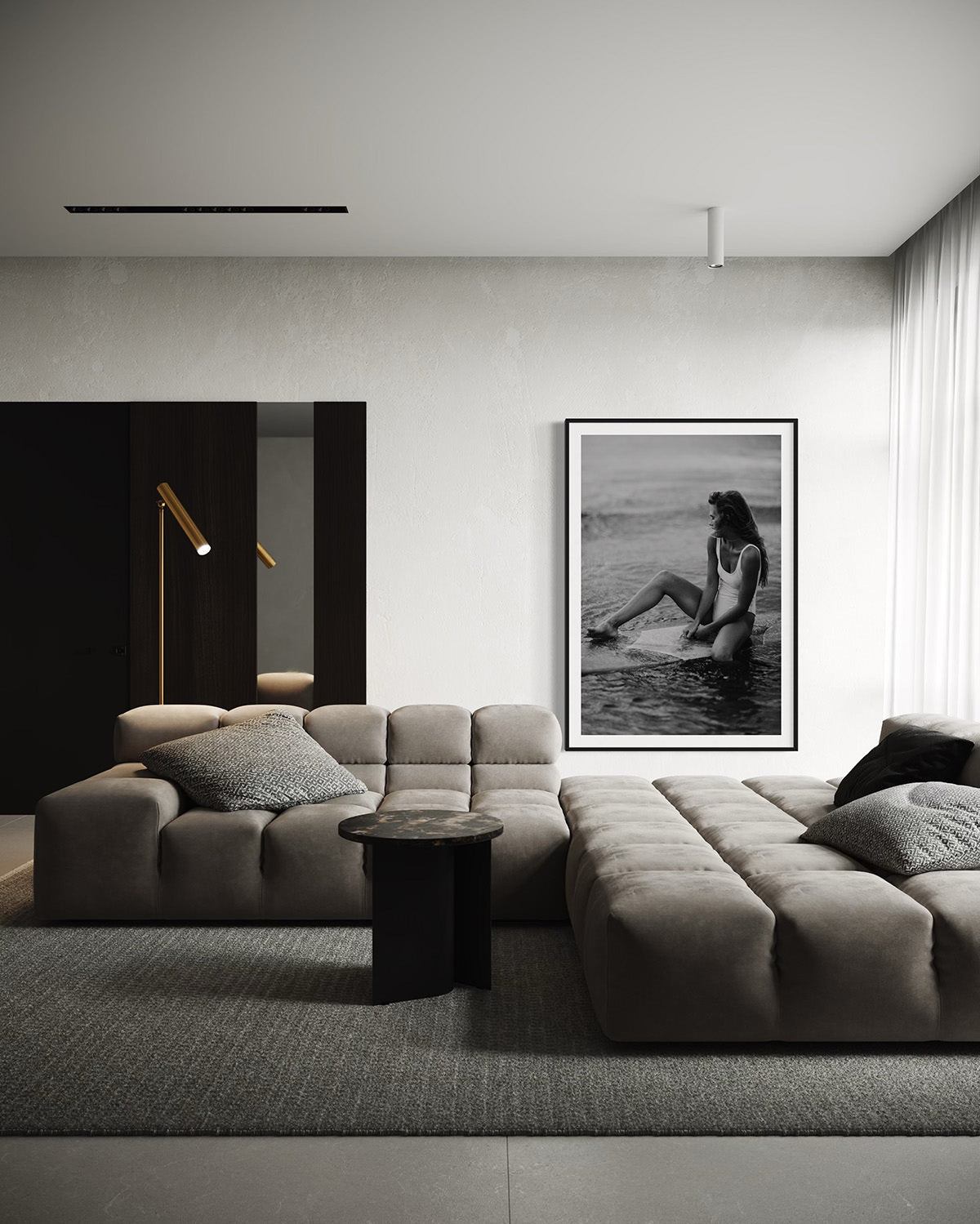 A modern living room with minimalist decor featuring the framed photography 'Riding Tide', highlighting a woman sitting on a surfboard, bringing a touch of coastal elegance.