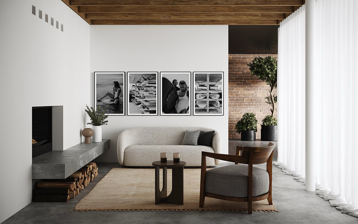 Charming interior featuring 'Riding Tide' framed art, depicting a serene moment of a woman on a surfboard, enhancing the coastal theme of the living space.