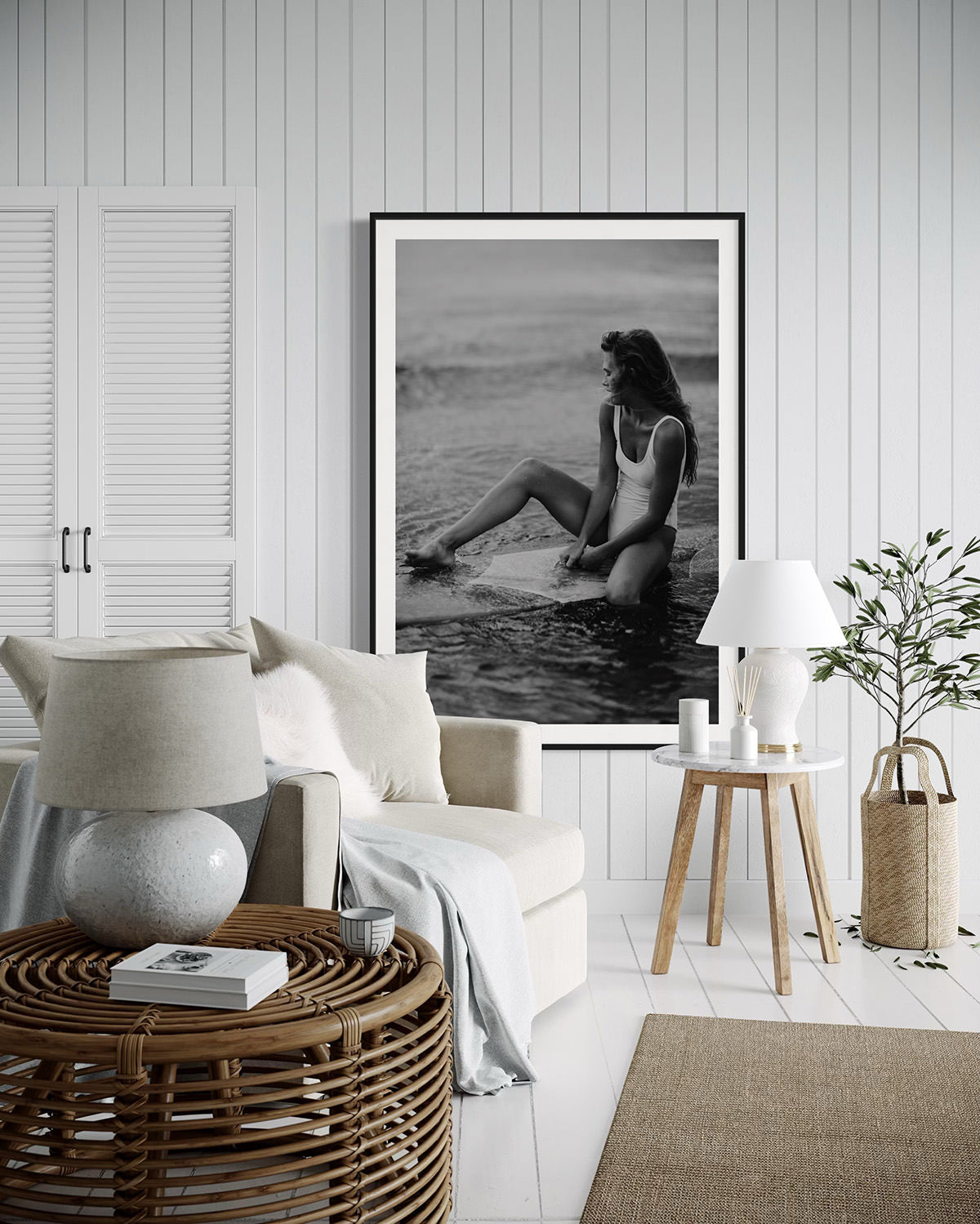 A cozy and bright room decorated with 'Riding Tide', a captivating photograph of a woman on a surfboard, creating a tranquil and beach-inspired atmosphere.